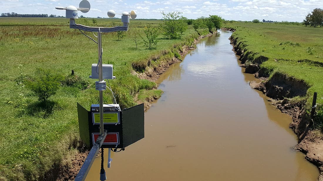 Field with solar-powered sensors and farmers